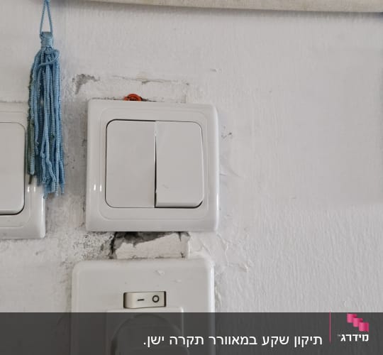 Two light switches and a power outlet with a plug